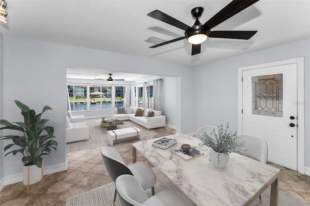4849 Floramar Ter, New Port Richey, FL 34652 - dining room featuring ceiling fan and a textured ceiling