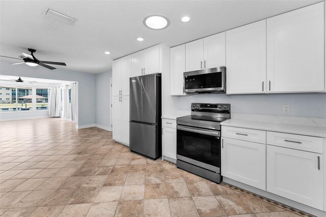 4849 Floramar Ter, New Port Richey, FL 34652 - kitchen featuring stainless steel appliances, a ceiling fan, light countertops, white cabinets, and recessed lighting