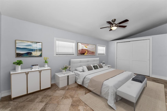 4849 Floramar Ter, New Port Richey, FL 34652 - bedroom with lofted ceiling, a closet, a ceiling fan, and light stone finish floors
