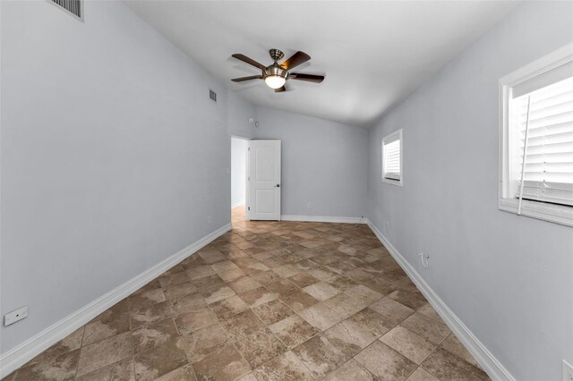 4849 Floramar Ter, New Port Richey, FL 34652 - spare room with stone finish floors, a ceiling fan, and vaulted ceiling