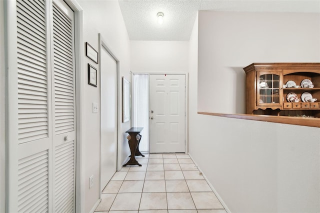 2868 Denmarsh Ct, Palm Harbor, FL 34684 - hall with light tile patterned flooring and a textured ceiling
