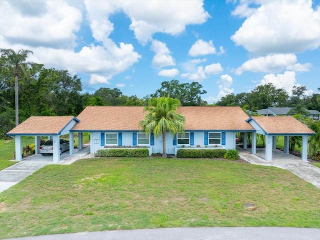 511 Foxglove Cir Unit B, Sun City Center, FL 33573 - view of front of house with concrete driveway, an attached carport, and a front lawn