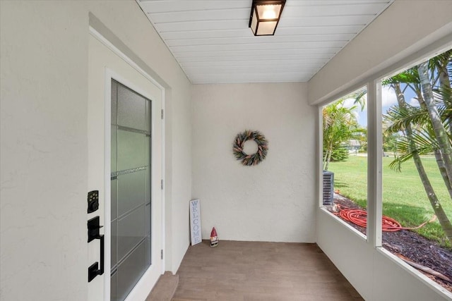 511 Foxglove Cir Unit B, Sun City Center, FL 33573 - unfurnished sunroom with wood finished floors and a textured wall