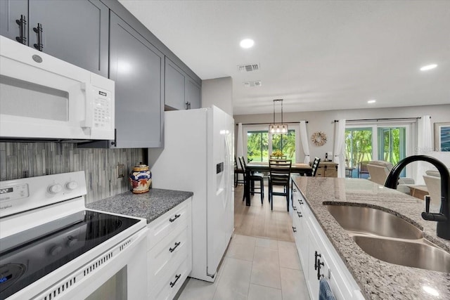 511 Foxglove Cir Unit B, Sun City Center, FL 33573 - kitchen featuring white appliances, recessed lighting, light stone counters, hanging light fixtures, and light tile patterned floors