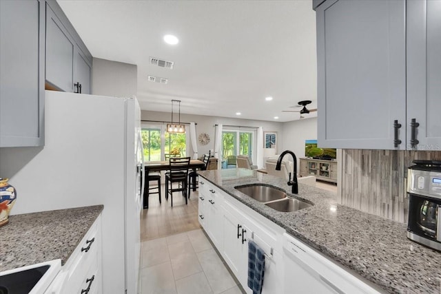 511 Foxglove Cir Unit B, Sun City Center, FL 33573 - kitchen featuring white appliances, recessed lighting, light stone counters, a ceiling fan, and light tile patterned floors