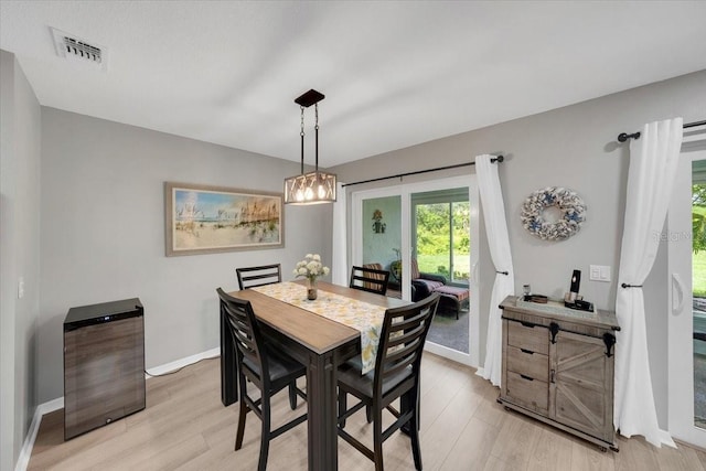 511 Foxglove Cir Unit B, Sun City Center, FL 33573 - dining space featuring light wood-style floors, a chandelier, and wine cooler