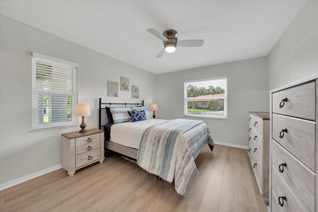 511 Foxglove Cir Unit B, Sun City Center, FL 33573 - bedroom featuring light wood finished floors and ceiling fan