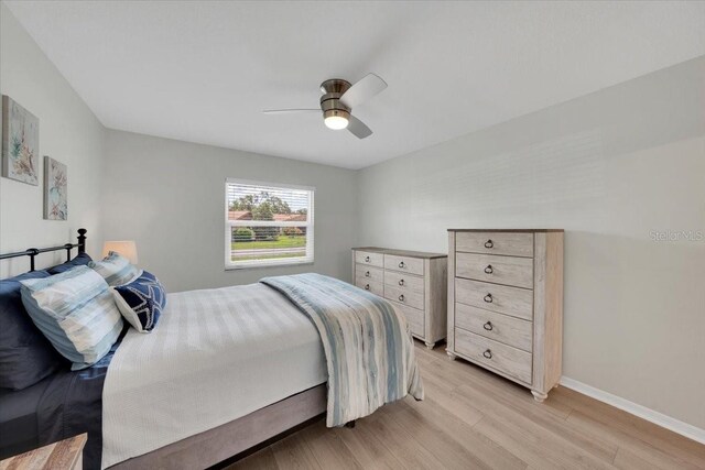 511 Foxglove Cir Unit B, Sun City Center, FL 33573 - bedroom with light wood-style flooring and ceiling fan