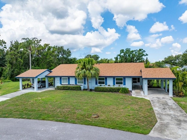 511 Foxglove Cir Unit B, Sun City Center, FL 33573 - ranch-style house featuring an attached carport, driveway, and a front yard