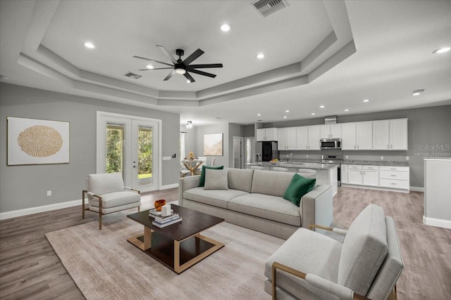 5352 W Corral Pl, Beverly Hills, FL 34465 - living room featuring a tray ceiling, ceiling fan, light wood-style floors, and recessed lighting