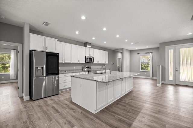 5352 W Corral Pl, Beverly Hills, FL 34465 - kitchen featuring appliances with stainless steel finishes, a kitchen island with sink, healthy amount of natural light, white cabinets, and recessed lighting