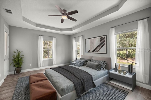 5352 W Corral Pl, Beverly Hills, FL 34465 - bedroom with a tray ceiling, wood finished floors, and a ceiling fan