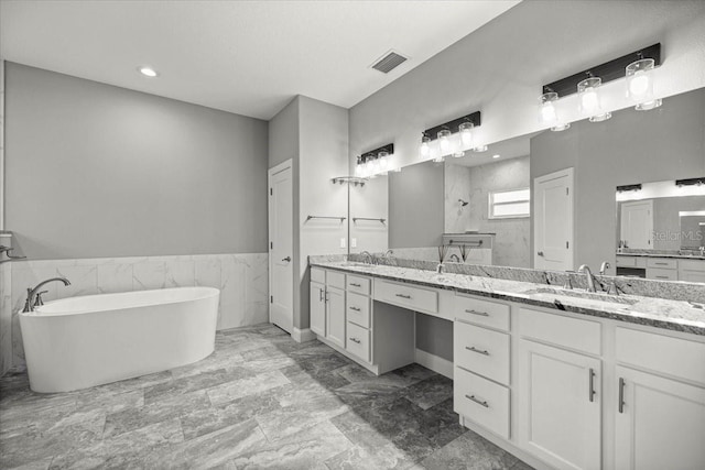 5352 W Corral Pl, Beverly Hills, FL 34465 - full bath with a freestanding bath, tiled shower, double vanity, marble look tile flooring, and recessed lighting