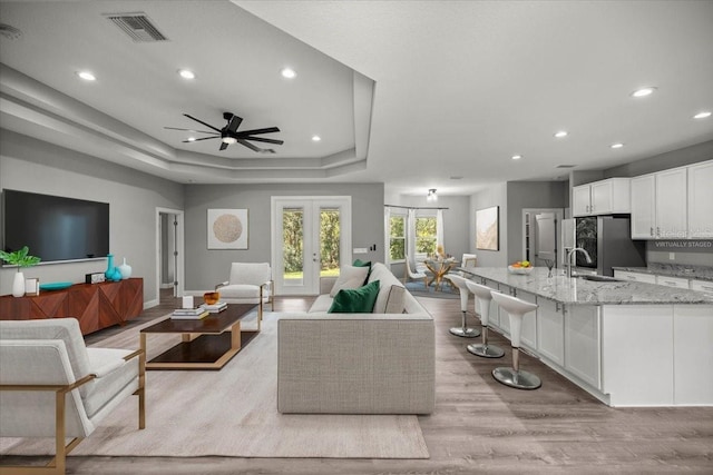 5352 W Corral Pl, Beverly Hills, FL 34465 - living room with light wood-type flooring, recessed lighting, a ceiling fan, french doors, and a tray ceiling