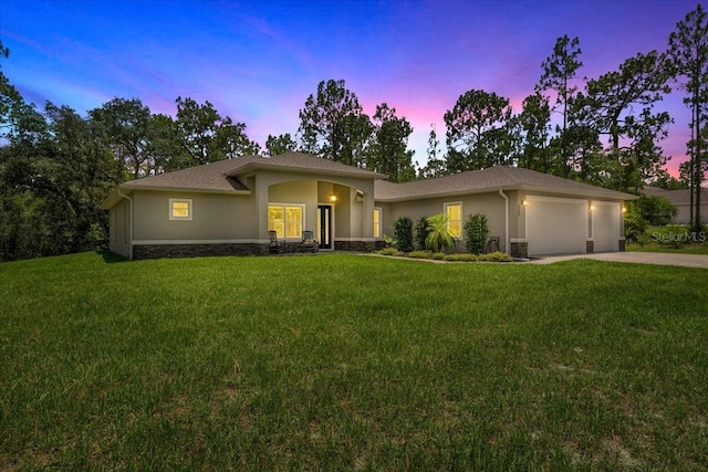 5352 W Corral Pl, Beverly Hills, FL 34465 - view of front facade featuring stucco siding, an attached garage, a front yard, driveway, and stone siding