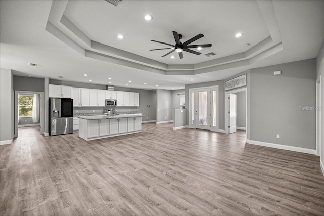 5352 W Corral Pl, Beverly Hills, FL 34465 - unfurnished living room with a raised ceiling, a ceiling fan, recessed lighting, and light wood-style flooring