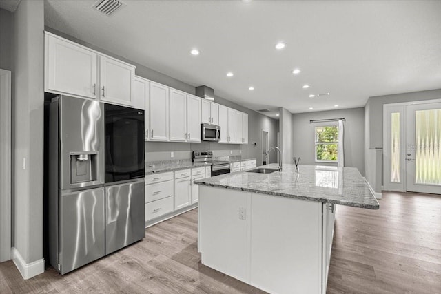 5352 W Corral Pl, Beverly Hills, FL 34465 - kitchen featuring appliances with stainless steel finishes, white cabinetry, a kitchen island with sink, light wood finished floors, and recessed lighting