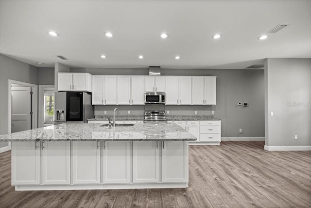 5352 W Corral Pl, Beverly Hills, FL 34465 - kitchen featuring appliances with stainless steel finishes, a spacious island, recessed lighting, white cabinetry, and light wood-type flooring