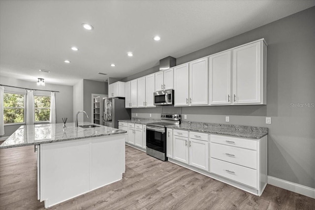 5352 W Corral Pl, Beverly Hills, FL 34465 - kitchen with appliances with stainless steel finishes, white cabinetry, recessed lighting, light wood-style floors, and a kitchen island with sink