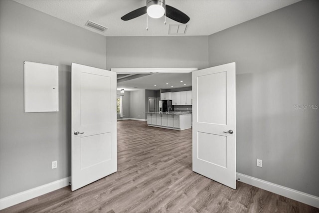 5352 W Corral Pl, Beverly Hills, FL 34465 - unfurnished living room with ceiling fan, wood finished floors, and vaulted ceiling