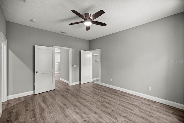 5352 W Corral Pl, Beverly Hills, FL 34465 - unfurnished bedroom with wood finished floors, a textured ceiling, and ceiling fan