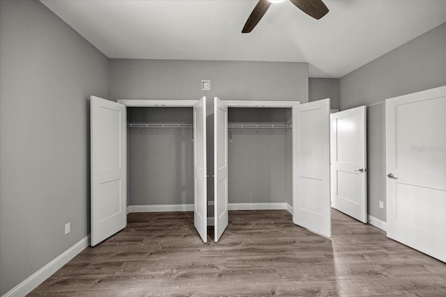 5352 W Corral Pl, Beverly Hills, FL 34465 - unfurnished bedroom featuring two closets, wood finished floors, and ceiling fan