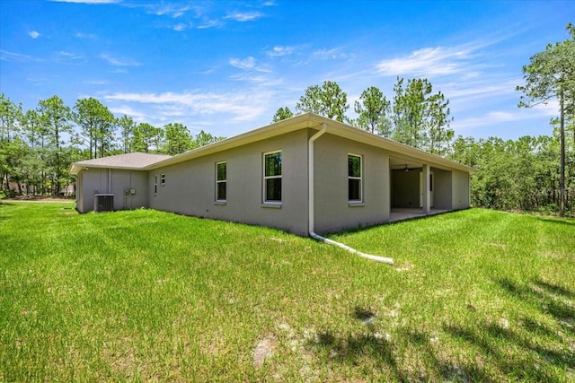 5352 W Corral Pl, Beverly Hills, FL 34465 - rear view of property featuring stucco siding and a lawn