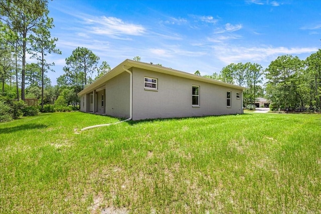 5352 W Corral Pl, Beverly Hills, FL 34465 - view of property exterior featuring stucco siding and a yard