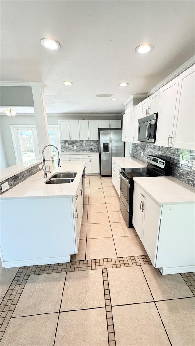 1507 W Le Compte Dr, Tampa, FL 33604 - kitchen with stainless steel appliances, backsplash, light tile patterned flooring, light countertops, and white cabinets