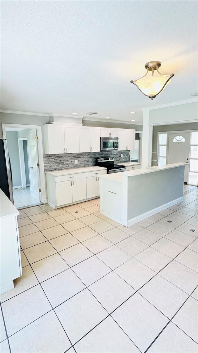 1507 W Le Compte Dr, Tampa, FL 33604 - kitchen with appliances with stainless steel finishes, decorative backsplash, a textured ceiling, white cabinets, and light countertops