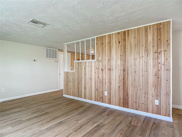 6632 Sierra Ter, New Port Richey, FL 34652 - empty room featuring wood finished floors and wooden walls