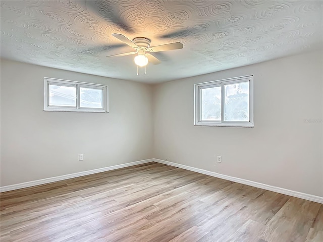 6632 Sierra Ter, New Port Richey, FL 34652 - unfurnished room featuring healthy amount of natural light, ceiling fan, and light wood finished floors