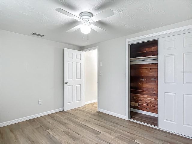 6632 Sierra Ter, New Port Richey, FL 34652 - unfurnished bedroom with light wood-type flooring, a closet, and a ceiling fan