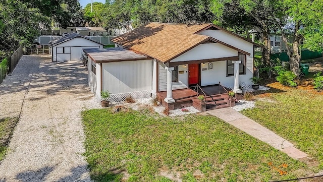 1217 E 29th Ave, Tampa, FL 33605 - view of front of house with a porch, a front yard, and roof with shingles