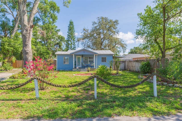 1912 E 97th Ave, Tampa, FL 33612 - view of front of house featuring a porch and a metal roof