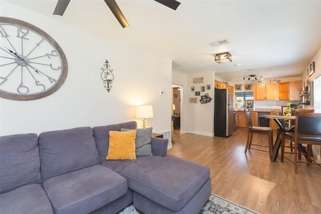 1912 E 97th Ave, Tampa, FL 33612 - living room featuring light wood-style flooring and a ceiling fan