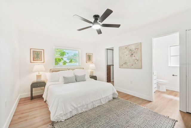 11779 82nd Ter, Seminole, FL 33772 - bedroom with light wood-style flooring, connected bathroom, and a ceiling fan