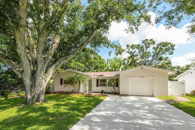 11779 82nd Ter, Seminole, FL 33772 - ranch-style home with concrete driveway, an attached garage, and a gate