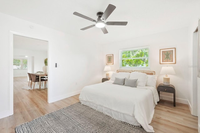 11779 82nd Ter, Seminole, FL 33772 - bedroom featuring light wood-type flooring, multiple windows, and a ceiling fan