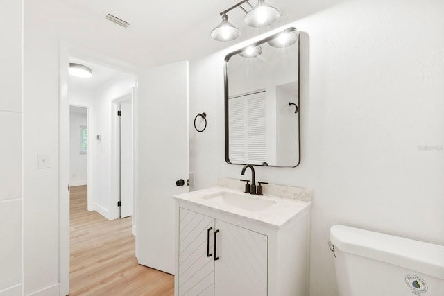 11779 82nd Ter, Seminole, FL 33772 - half bathroom featuring vanity and wood finished floors