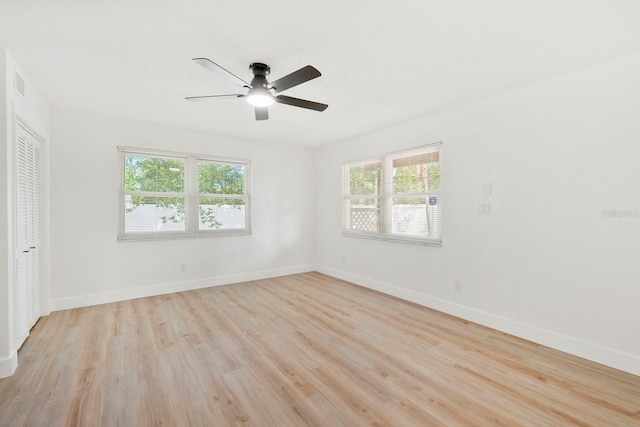 11779 82nd Ter, Seminole, FL 33772 - unfurnished bedroom featuring multiple windows, light wood-style flooring, ceiling fan, and a closet