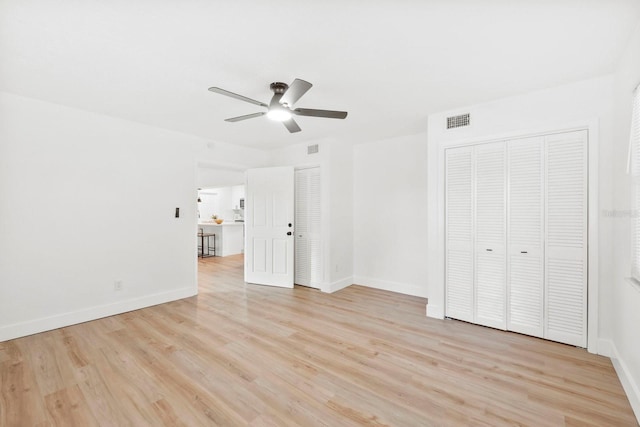 11779 82nd Ter, Seminole, FL 33772 - unfurnished living room featuring a ceiling fan and light wood-style flooring