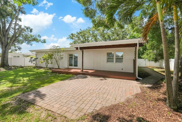 11779 82nd Ter, Seminole, FL 33772 - rear view of property with a fenced backyard, a wooden deck, and a patio area
