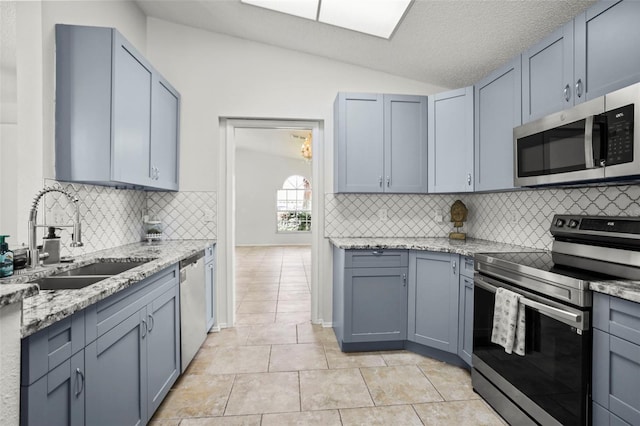 4948 Ridgemoor Cir, Palm Harbor, FL 34685 - kitchen with appliances with stainless steel finishes, vaulted ceiling, light stone counters, tasteful backsplash, and light tile patterned flooring