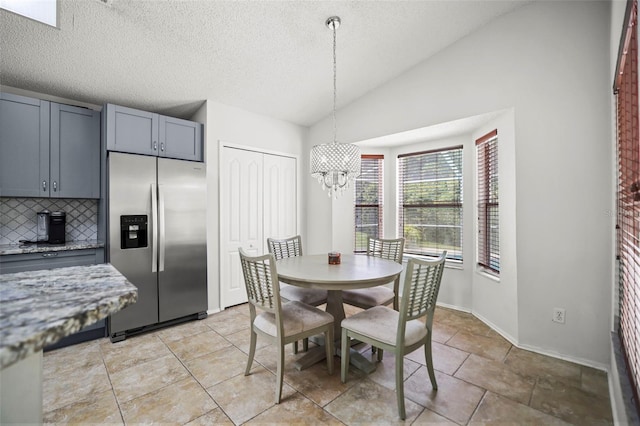 4948 Ridgemoor Cir, Palm Harbor, FL 34685 - dining area featuring lofted ceiling, a chandelier, and a textured ceiling