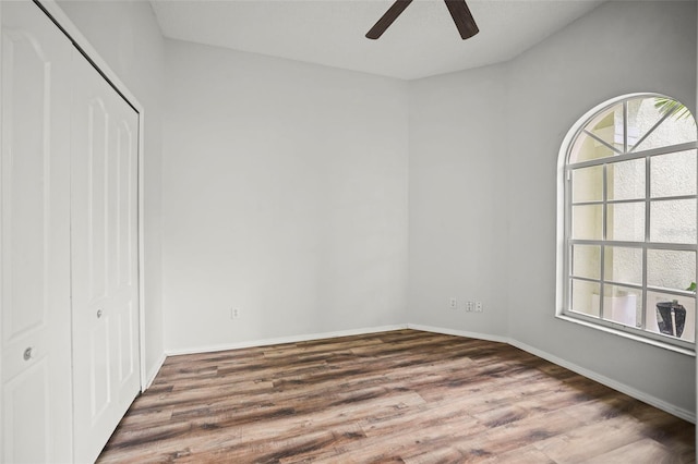 4948 Ridgemoor Cir, Palm Harbor, FL 34685 - unfurnished bedroom with a closet, wood finished floors, and ceiling fan
