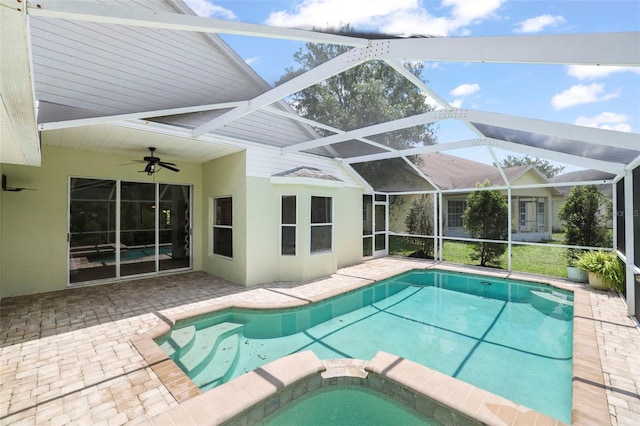 4948 Ridgemoor Cir, Palm Harbor, FL 34685 - view of swimming pool featuring a ceiling fan, a patio, a pool with connected hot tub, and glass enclosure