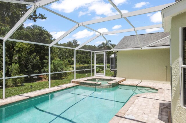 4948 Ridgemoor Cir, Palm Harbor, FL 34685 - view of swimming pool featuring a pool with connected hot tub, a patio area, and glass enclosure