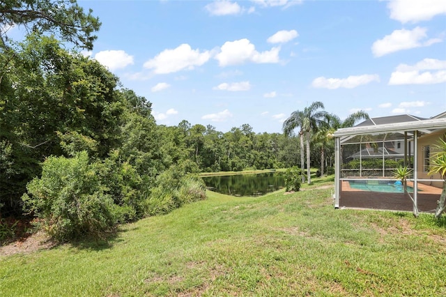 4948 Ridgemoor Cir, Palm Harbor, FL 34685 - view of green lawn featuring a lanai, an outdoor pool, and a water view