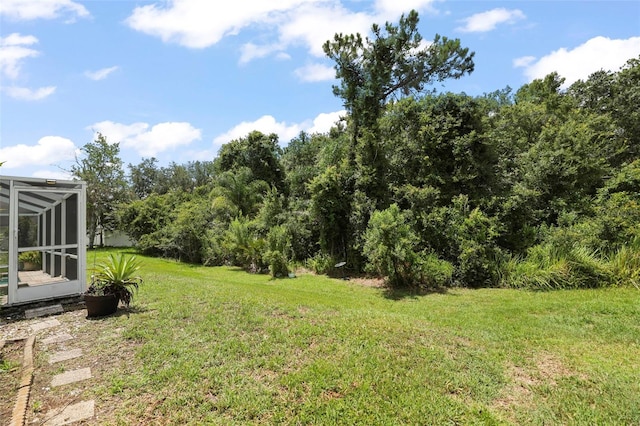 4948 Ridgemoor Cir, Palm Harbor, FL 34685 - view of green lawn with glass enclosure